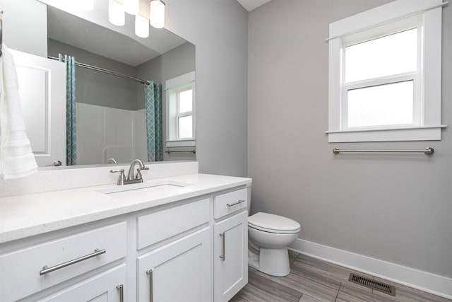 16206 Brookview Dr, Urbandale, IA 50323 - bathroom with toilet, baseboards, vanity, wood finished floors, and a shower with curtain