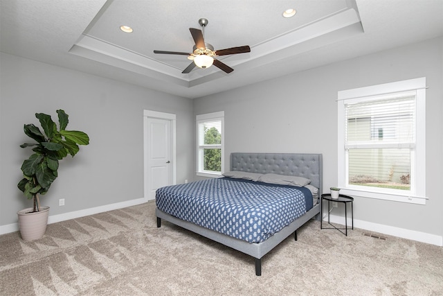 16206 Brookview Dr, Urbandale, IA 50323 - carpeted bedroom featuring a tray ceiling, baseboards, recessed lighting, and a ceiling fan