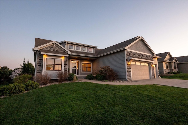 16206 Brookview Dr, Urbandale, IA 50323 - view of front facade with stone siding, a garage, a lawn, and concrete driveway