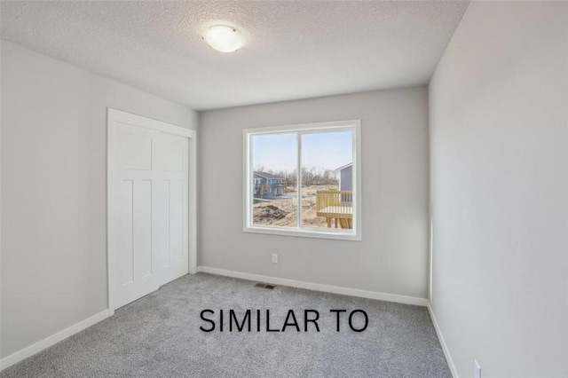 unfurnished bedroom with baseboards, carpet floors, and visible vents
