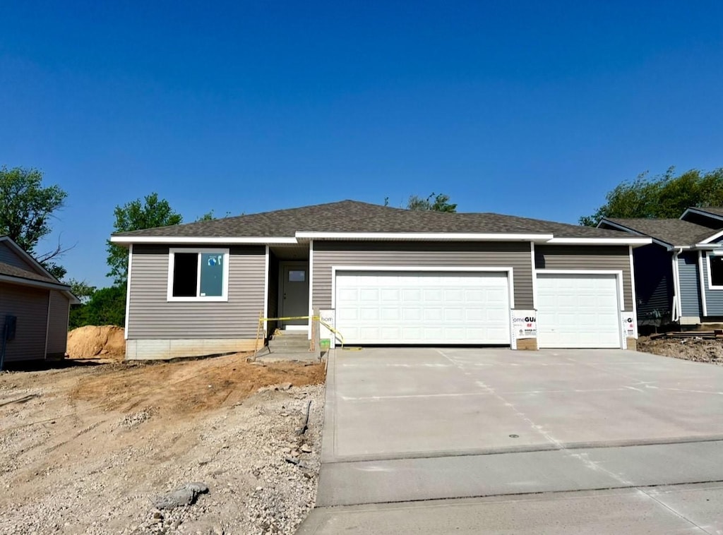 207 S Walnut Dr, Norwalk, IA 50211 - ranch-style home featuring a garage and driveway