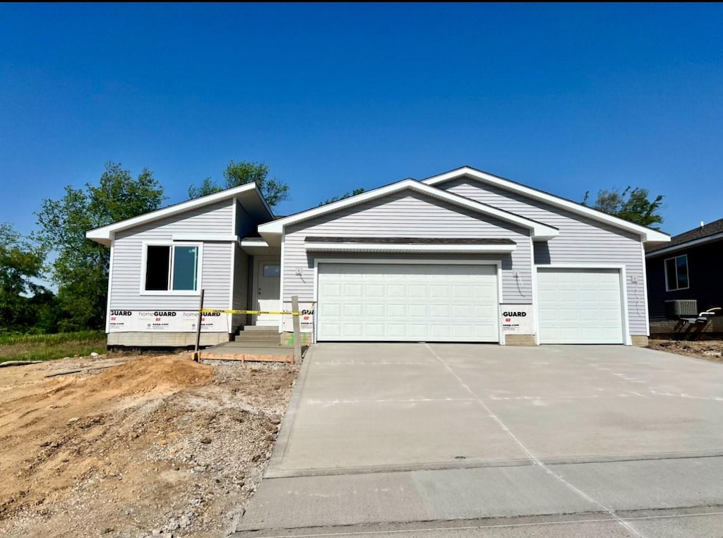 213 S Walnut Dr, Norwalk, IA 50211 - view of front facade with concrete driveway and a garage
