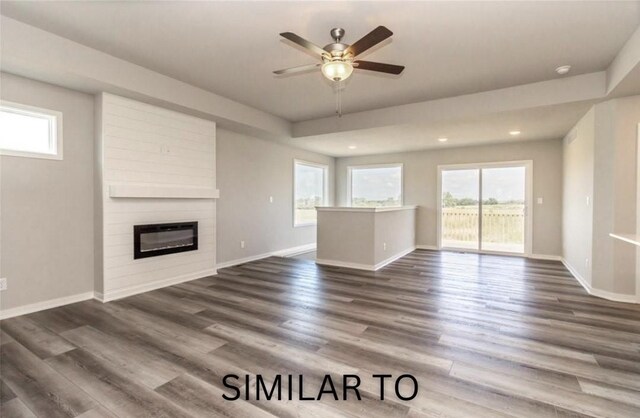 213 S Walnut Dr, Norwalk, IA 50211 - unfurnished living room featuring healthy amount of natural light, a fireplace, ceiling fan, recessed lighting, and dark wood-style floors