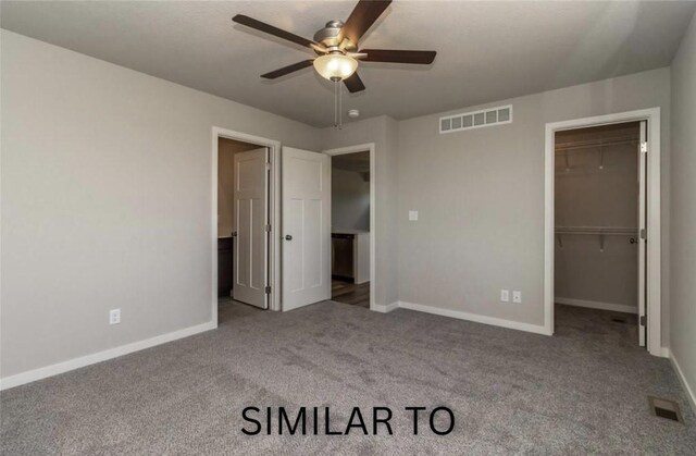213 S Walnut Dr, Norwalk, IA 50211 - unfurnished bedroom with carpet floors, a walk in closet, a closet, and a ceiling fan
