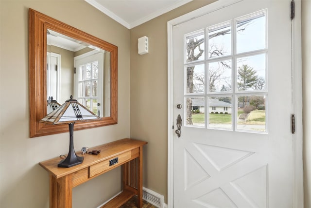 doorway to outside featuring baseboards, visible vents, a wealth of natural light, and ornamental molding