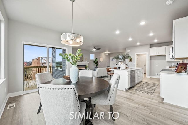 1404 S 91st St, West Des Moines, IA 50263 - dining space with light wood-style floors, a ceiling fan, recessed lighting, and a chandelier