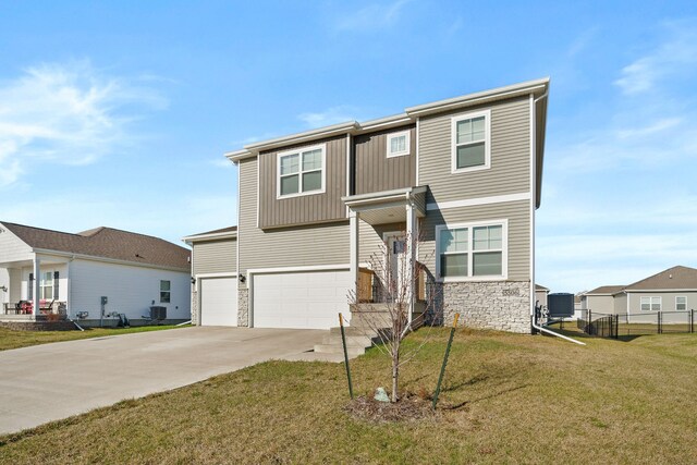 5506 145th St, Urbandale, IA 50323 - view of front of property with stone siding, a garage, and concrete driveway