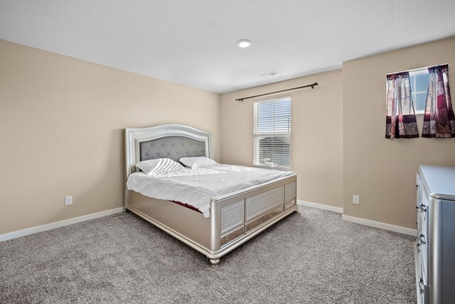 carpeted bedroom featuring baseboards