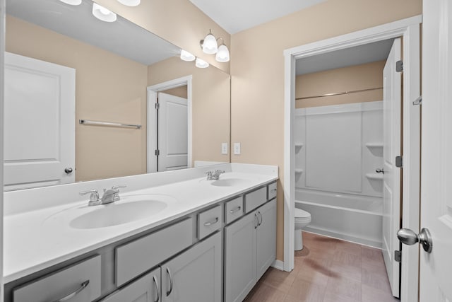 full bath with toilet, double vanity, tile patterned floors, and bathtub / shower combination