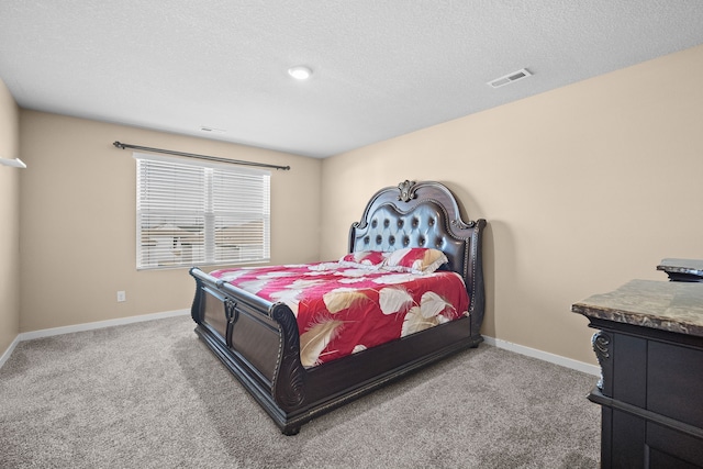 bedroom featuring carpet flooring, baseboards, and a textured ceiling