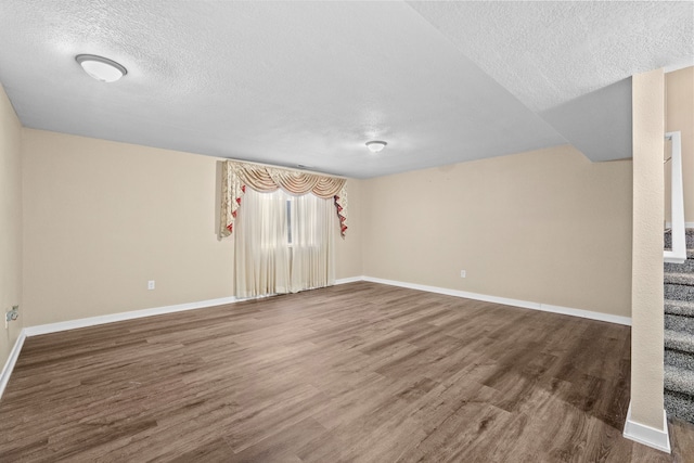 5506 145th St, Urbandale, IA 50323 - spare room with a textured ceiling, wood finished floors, and stairs