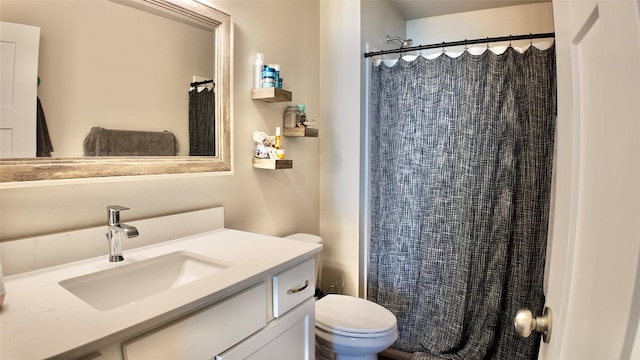 bathroom featuring toilet, a shower with shower curtain, and vanity