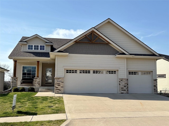 craftsman-style home featuring a shingled roof, a garage, stone siding, and driveway