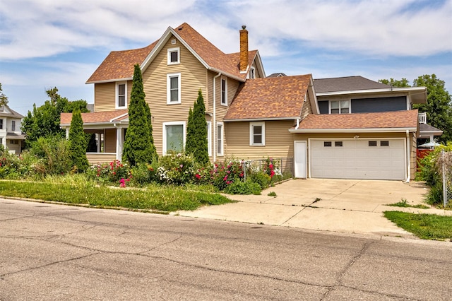 301 N 4th St, Marshalltown, IA 50158 - view of front of house with driveway, roof with shingles, and a garage
