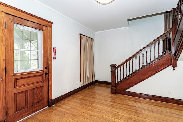 301 N 4th St, Marshalltown, IA 50158 - foyer with light wood-type flooring, stairs, and ornamental molding