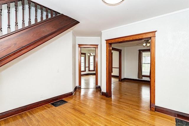 301 N 4th St, Marshalltown, IA 50158 - interior space with light wood-style flooring, ornamental molding, and a chandelier