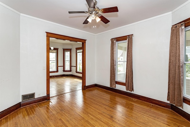 301 N 4th St, Marshalltown, IA 50158 - unfurnished room with wood-type flooring, healthy amount of natural light, ceiling fan, and ornamental molding