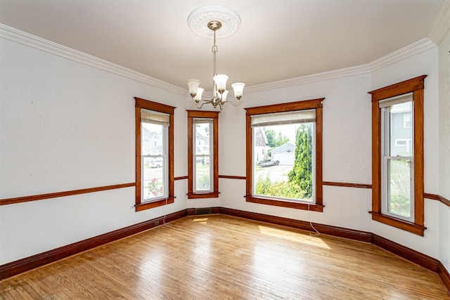 301 N 4th St, Marshalltown, IA 50158 - unfurnished room featuring a chandelier, light wood-type flooring, and ornamental molding