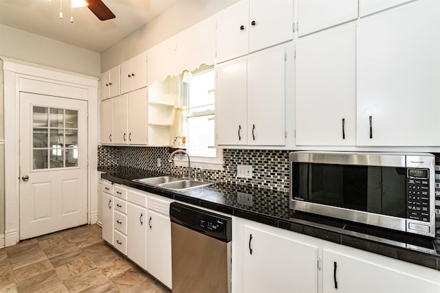301 N 4th St, Marshalltown, IA 50158 - kitchen featuring stainless steel appliances, white cabinetry, and tasteful backsplash