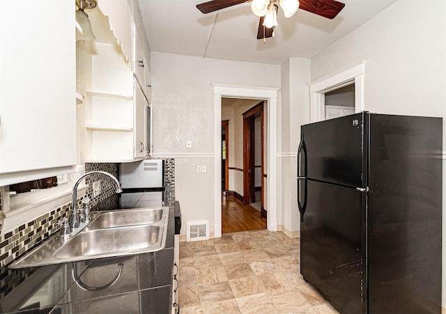 301 N 4th St, Marshalltown, IA 50158 - kitchen featuring freestanding refrigerator, open shelves, a ceiling fan, white cabinets, and decorative backsplash