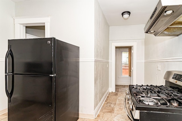301 N 4th St, Marshalltown, IA 50158 - kitchen featuring freestanding refrigerator, gas stove, and ventilation hood
