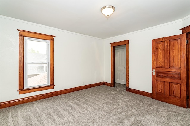 301 N 4th St, Marshalltown, IA 50158 - carpeted empty room with baseboards and crown molding