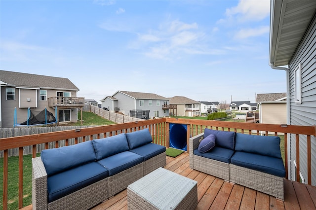 2424 N 7th Ave E, Newton, IA 50208 - wooden terrace with outdoor lounge area, a trampoline, a residential view, and a fenced backyard