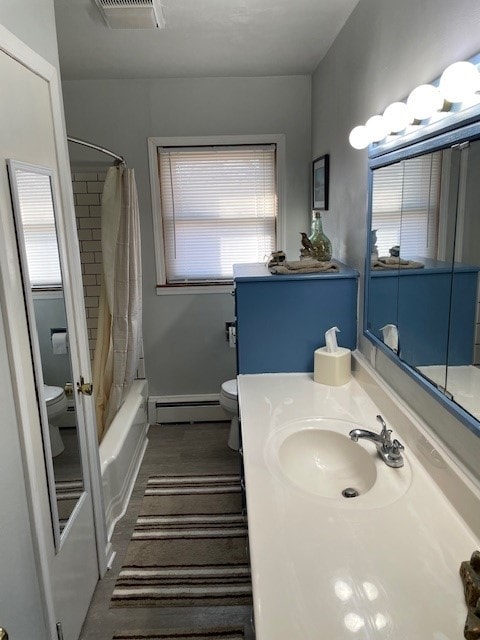 320 1st Ave, Grinnell, IA 50112 - full bath with baseboard heating, vanity, and shower / tub combo