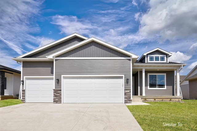 craftsman-style house featuring concrete driveway, a front lawn, stone siding, covered porch, and a garage