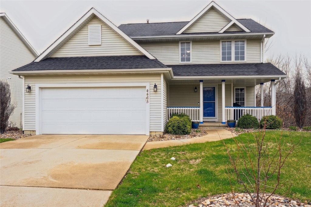 4465 Meadow Valley Dr, West Des Moines, IA 50265 - traditional-style house featuring driveway, a porch, a garage, and roof with shingles