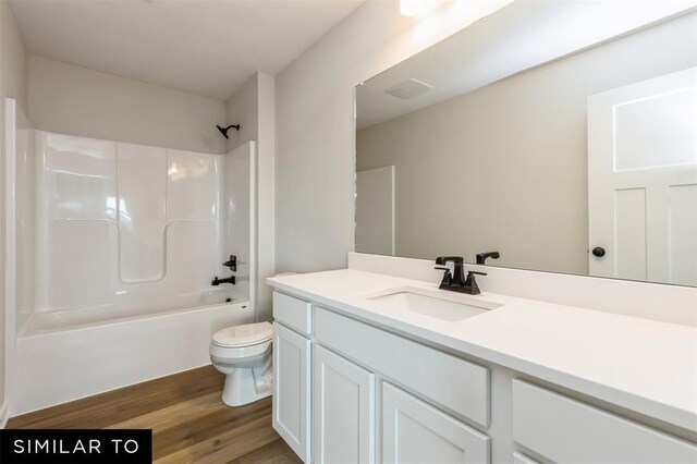 1012 Willow Valley Dr, Norwalk, IA 50211 - bathroom featuring tub / shower combination, toilet, vanity, and wood finished floors