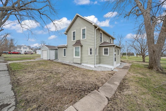 308 Pine St, Williams, IA 50271 - view of property exterior with a garage, a yard, driveway, and an outdoor structure