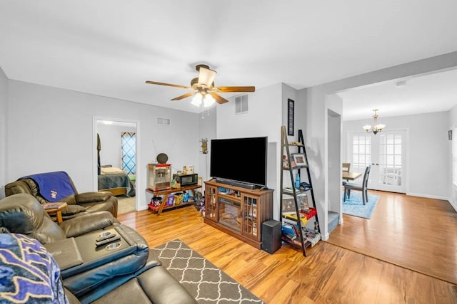 308 Pine St, Williams, IA 50271 - living room with light wood finished floors, visible vents, ceiling fan with notable chandelier, and baseboards
