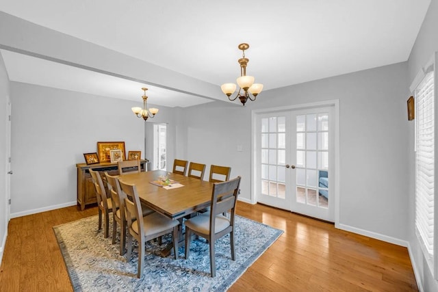 308 Pine St, Williams, IA 50271 - dining space featuring light wood-style floors, french doors, a notable chandelier, and baseboards
