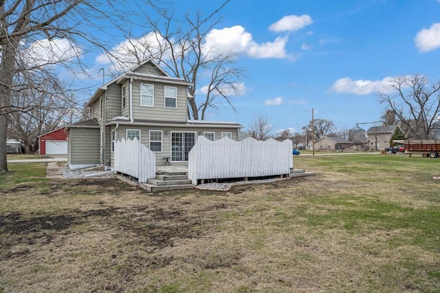 308 Pine St, Williams, IA 50271 - back of property featuring a garage, a yard, and a deck
