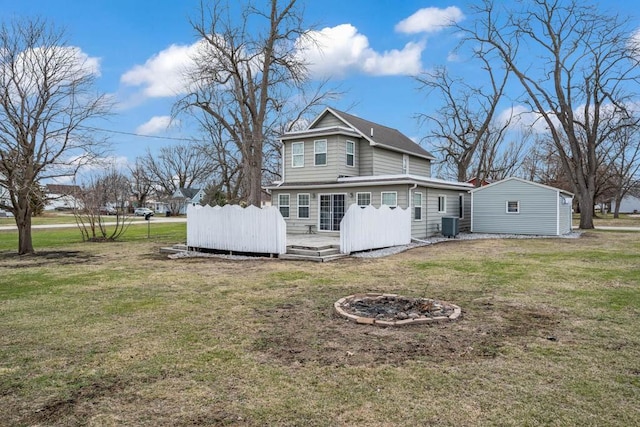 308 Pine St, Williams, IA 50271 - back of property featuring a fire pit, a yard, a deck, and central AC