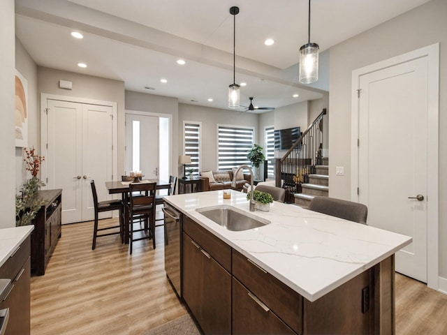 804 E 2nd St, Des Moines, IA 50309 - kitchen featuring recessed lighting, dark brown cabinetry, a sink, light wood-type flooring, and stainless steel dishwasher
