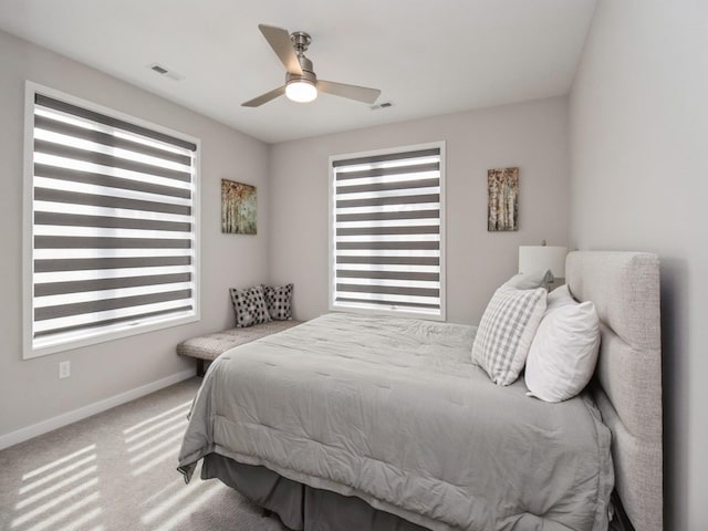804 E 2nd St, Des Moines, IA 50309 - carpeted bedroom featuring baseboards, multiple windows, ceiling fan, and visible vents