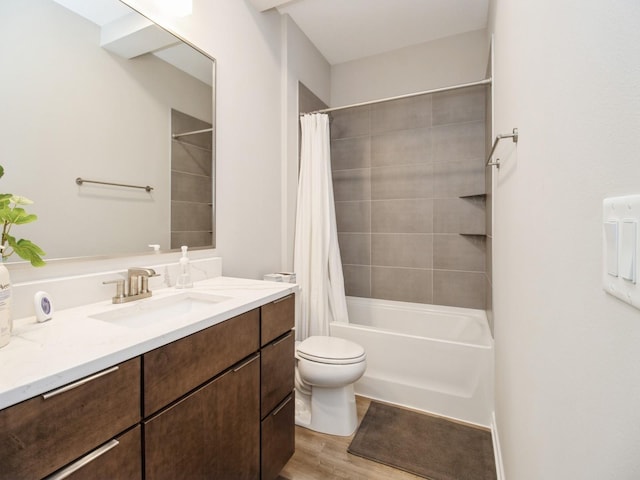 804 E 2nd St, Des Moines, IA 50309 - full bath with wood finished floors, toilet, shower / tub combo with curtain, and vanity