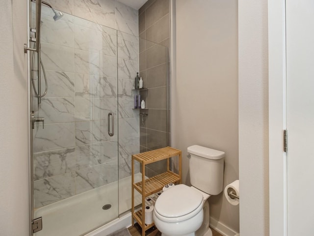 804 E 2nd St, Des Moines, IA 50309 - bathroom featuring baseboards, toilet, and a stall shower