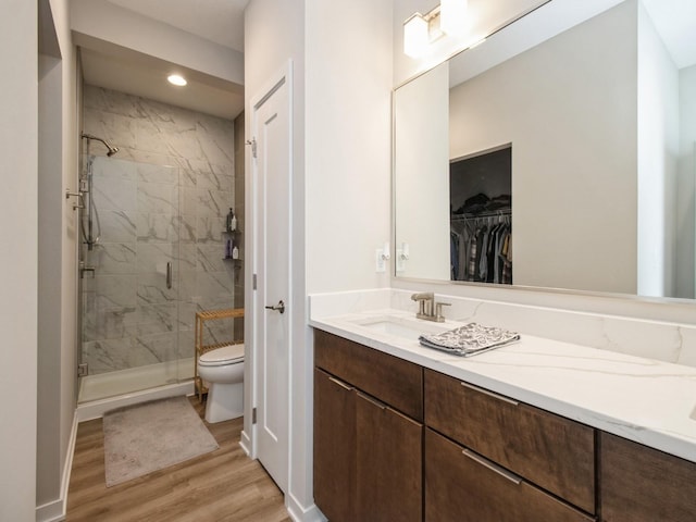 804 E 2nd St, Des Moines, IA 50309 - full bathroom featuring wood finished floors, toilet, recessed lighting, vanity, and a stall shower