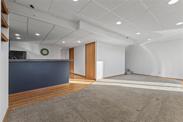 400 Coral Ridge Blvd, Pleasant Hill, IA 50327 - interior space featuring light carpet, light wood-style flooring, baseboards, recessed lighting, and a drop ceiling