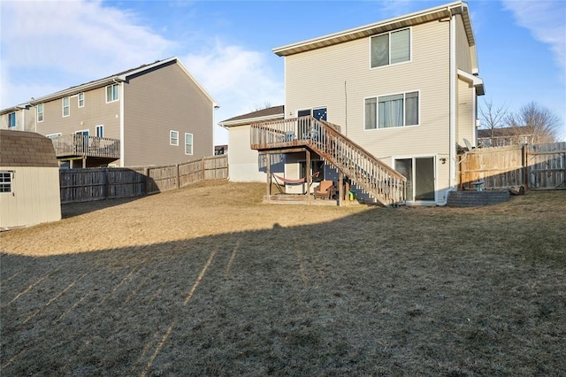 400 Coral Ridge Blvd, Pleasant Hill, IA 50327 - rear view of property featuring a wooden deck, a fenced backyard, stairway, an outdoor structure, and a yard