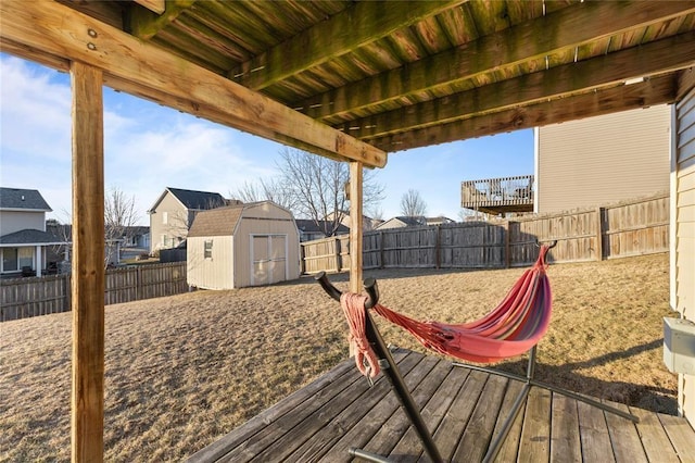 400 Coral Ridge Blvd, Pleasant Hill, IA 50327 - wooden terrace featuring a fenced backyard, a residential view, an outdoor structure, and a storage shed