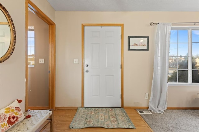 400 Coral Ridge Blvd, Pleasant Hill, IA 50327 - foyer entrance with wood finished floors, baseboards, and visible vents