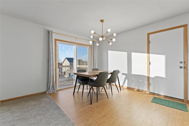 400 Coral Ridge Blvd, Pleasant Hill, IA 50327 - dining area with a textured ceiling, wood finished floors, baseboards, and an inviting chandelier
