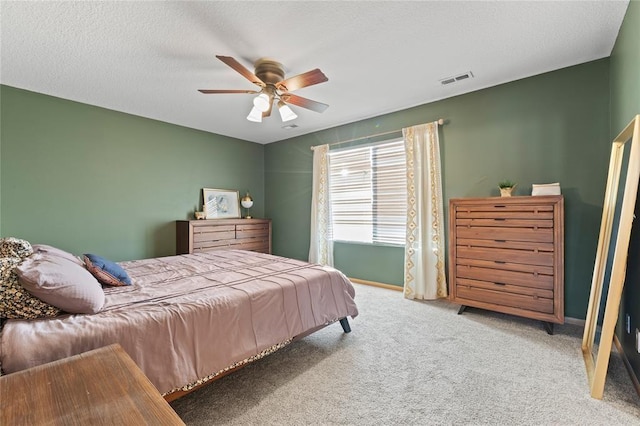 400 Coral Ridge Blvd, Pleasant Hill, IA 50327 - carpeted bedroom with visible vents, baseboards, ceiling fan, and a textured ceiling