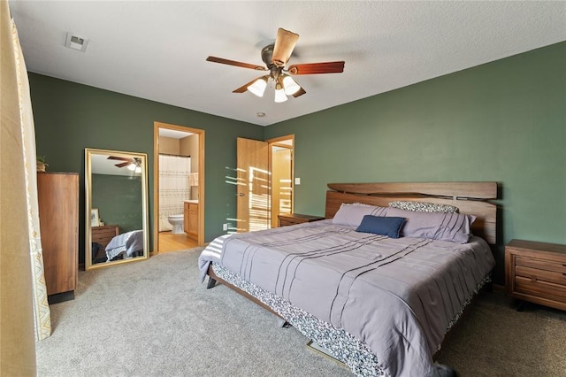 400 Coral Ridge Blvd, Pleasant Hill, IA 50327 - carpeted bedroom featuring a ceiling fan, connected bathroom, and visible vents