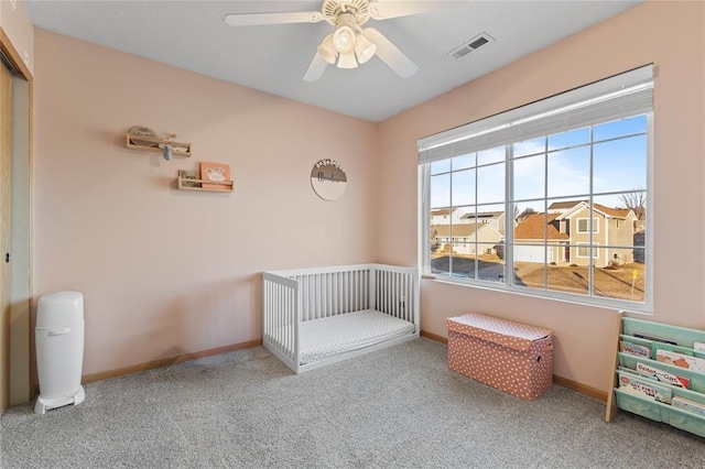400 Coral Ridge Blvd, Pleasant Hill, IA 50327 - bedroom featuring visible vents, a crib, baseboards, ceiling fan, and carpet floors