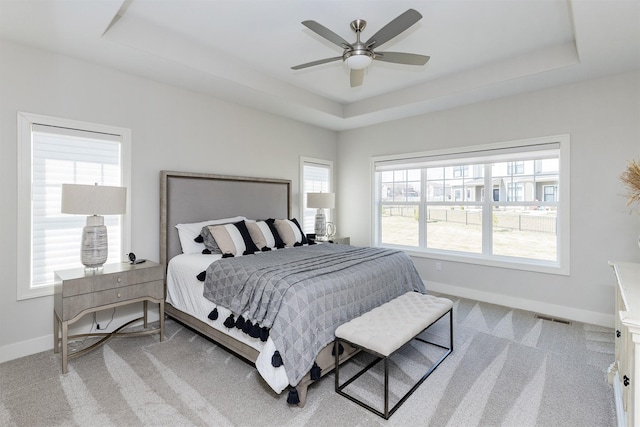 2426 SW Vineyard Ln, Ankeny, IA 50023 - carpeted bedroom featuring ceiling fan, baseboards, a tray ceiling, and visible vents